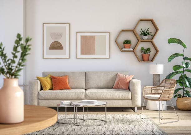 living room interior with beige colored furniture and wooden wall art