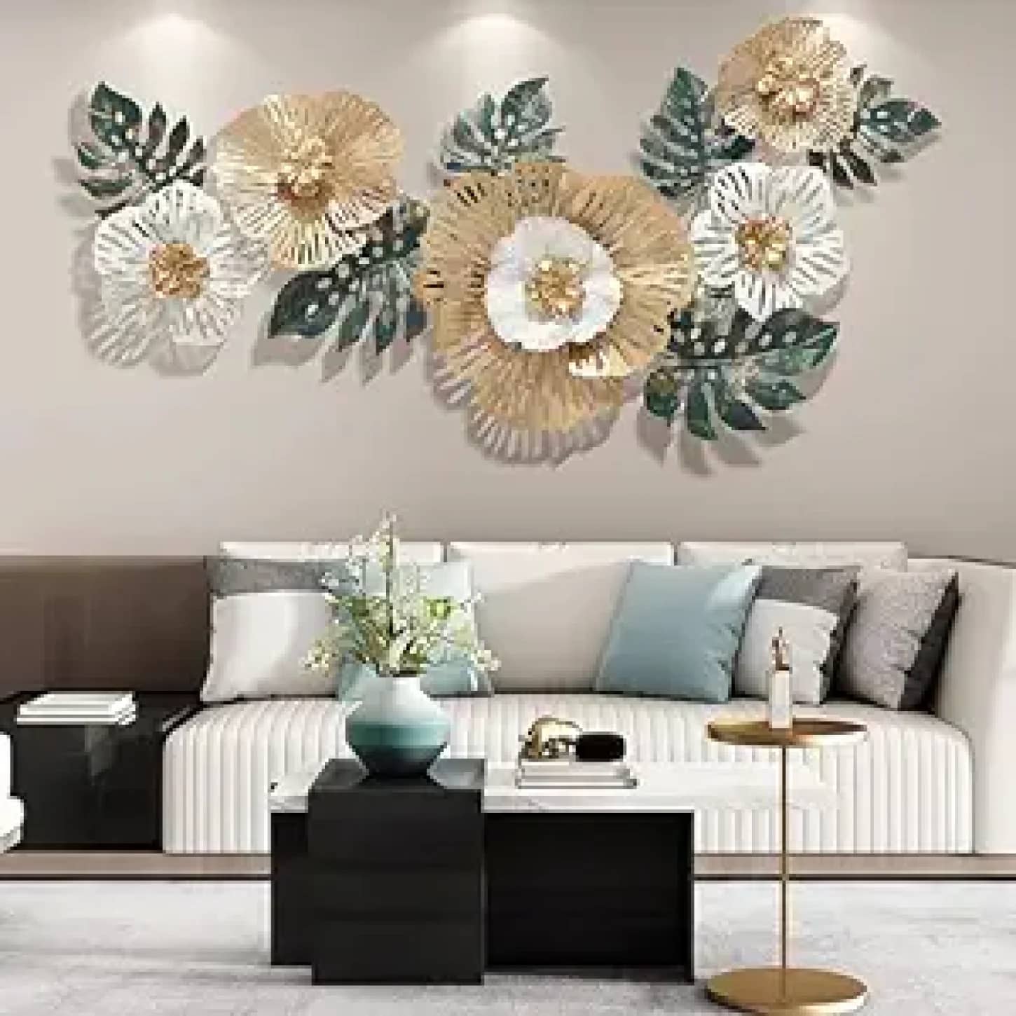 a white couch with gold and white flowers on the wall